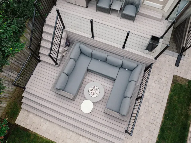 Two-level Toronto deck with clear glass panels and black aluminum picket railings