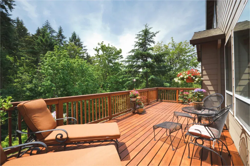 Wood deck with lounge chairs, timber railings and a leafy garden outlook