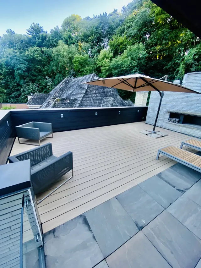 Finished AZEK PVC roof deck with outdoor seating and an umbrella