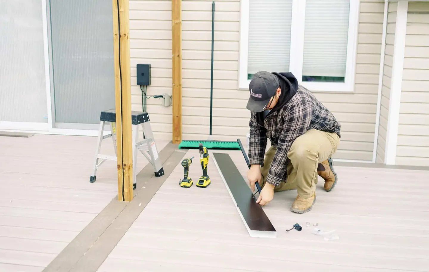 Ottawa Deck Builders installer fitting trim on a residential deck